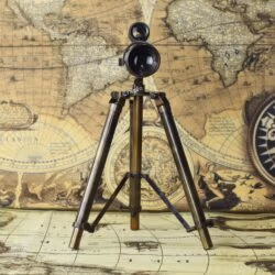 The adjustable wooden and brass tripod stand of the vintage tabletop telescope.