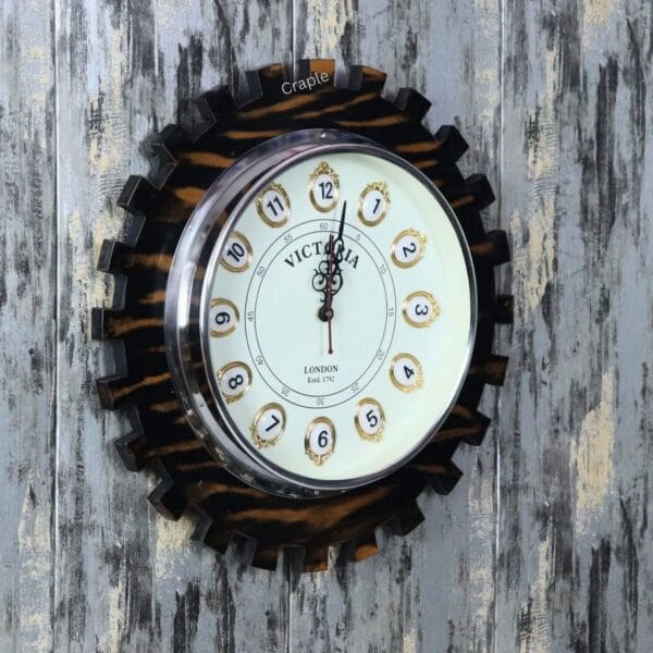 Angled view of the decorative gear-shaped wooden clock, showing the depth of the cog teeth and the rustic finish.