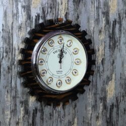A side perspective of the large wooden cog-shaped clock, highlighting the contrast between the wood frame and the clock face.