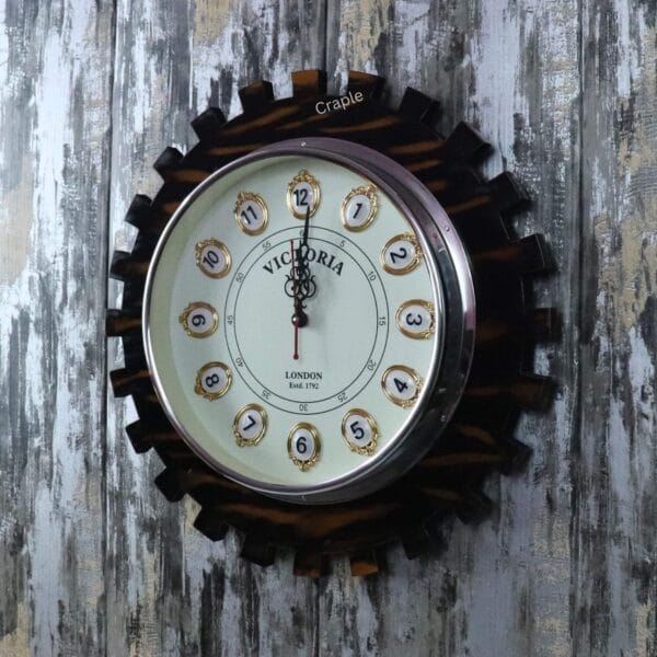 Close-up of the "Victoria London" clock face with ornate hands, set within the dark, gear-toothed wooden frame.