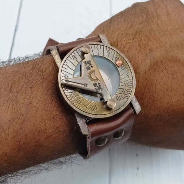 Side view of the antique brass wrist sundial compass being worn, highlighting the thick leather strap and brass casing.