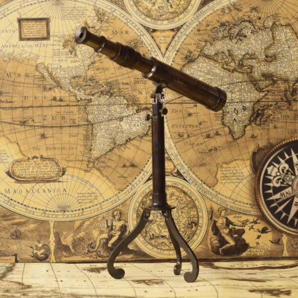 Vintage W. Ottway brass telescope with a black antique finish, mounted on a decorative foldable tripod stand.