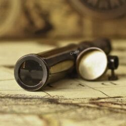 Close-up of the objective lens and brass cap of the antique replica W. Ottway telescope.