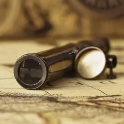 Close-up of the objective lens and brass cap of the antique replica W. Ottway telescope.