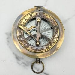 Top-down view of the closed sundial compass, showing the engraved Roman numerals and sundial on the lid.