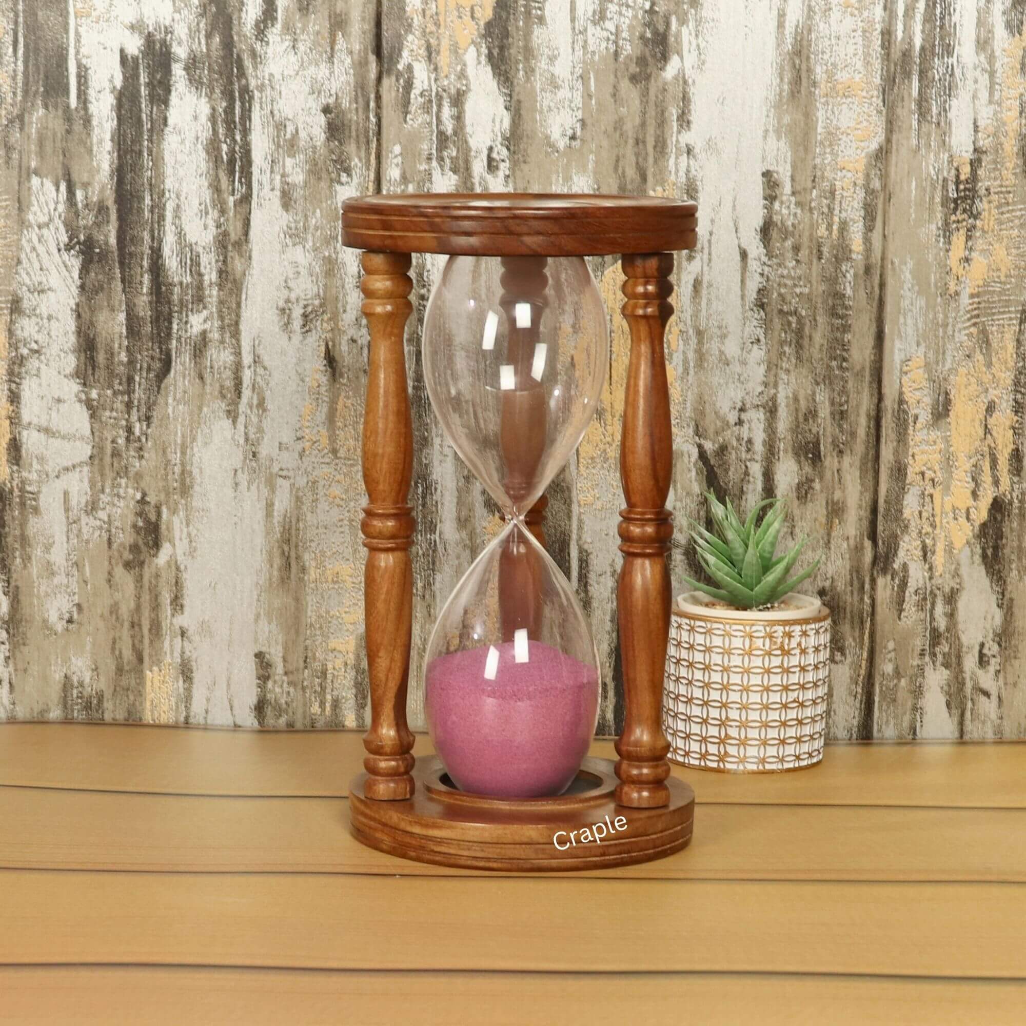 1 Hour Rosewood Hourglass-1 A large 1-hour hourglass with a handcrafted rosewood frame, turned pillars, and vibrant pink sand.