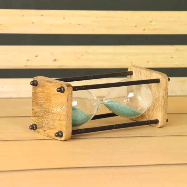 Close-up side view of the rustic hourglass, highlighting the texture of the natural wood base and the black brass hardware.