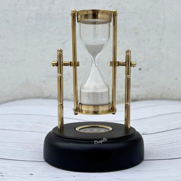 Front view of the 3-minute white sand hourglass, showcasing its polished brass pillars and pivoting frame.