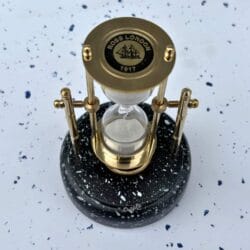 Top view of the rotating sand timer, detailing the "Ross London 1917" engraving on the brass top plate.