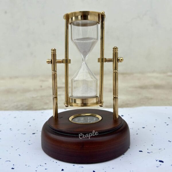 A classic front view of the 3-minute hourglass, showing the brass frame, white sand, and dark wooden base.