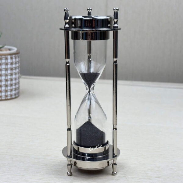 A 3-in-1 desktop accessory with a nickel-finish brass frame, shown as a 3-minute black sand hourglass.