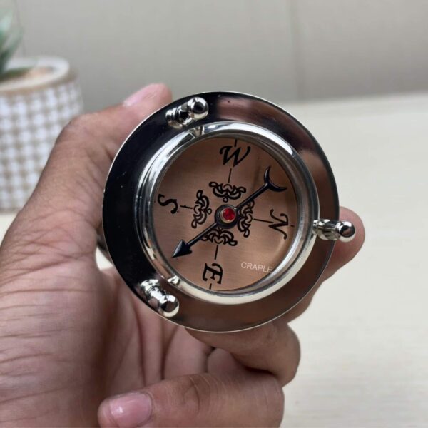 Close-up of the top of the hourglass, showing the built-in directional magnetic compass.