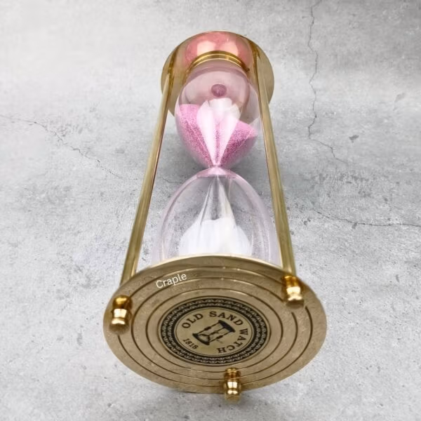 Close-up of the engraved top plate of the vintage-style brass hourglass.