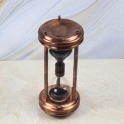 An angled view of the 5-minute black sand hourglass, highlighting its classic shape and copper finish.