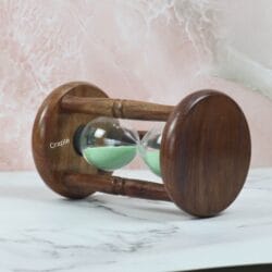 The rosewood hourglass resting on its side, showcasing the rich wood grain of the circular base and pillars.