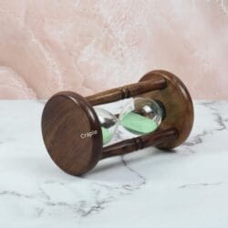 Angled view of the 5-minute sand timer lying down, highlighting its classic wooden construction.