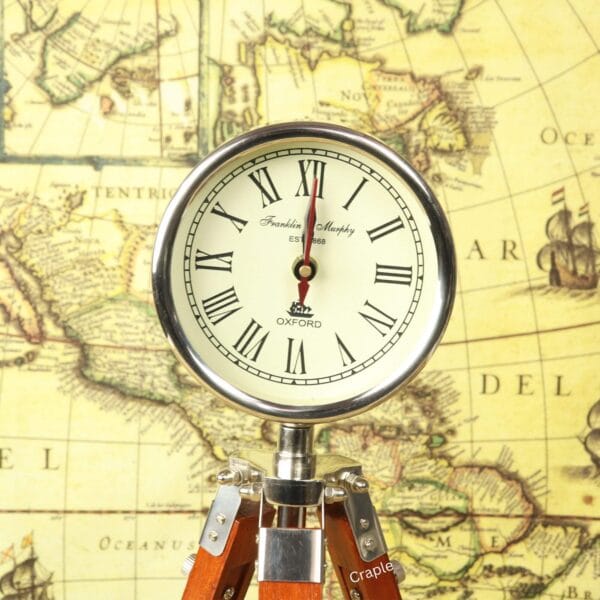 Close-up of the antique-style clock face, showing black Roman numerals and ornate hands on a cream dial.