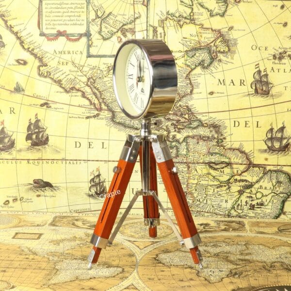 Side profile of the nickel-finished round clock mounted on its adjustable wooden and brass tripod.