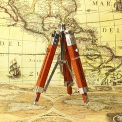 The adjustable wooden and nickel-finished tripod stand shown with its legs folded together.
