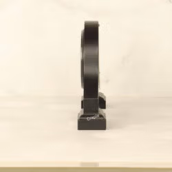 Side profile of the black wooden desk clock, highlighting its sturdy base and elegant silhouette.