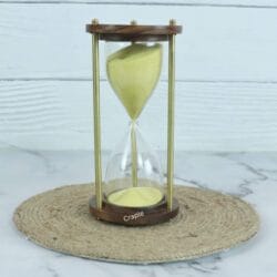 A classic 3-minute hourglass with bright yellow sand, framed by dark wooden bases and brass pillars.
