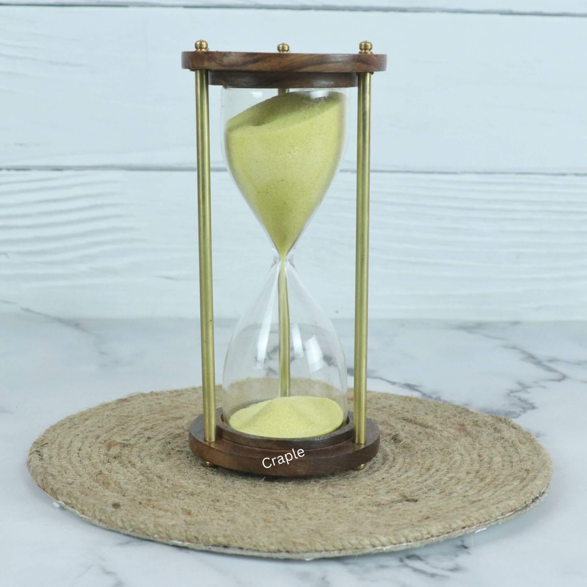 Classic Wood & Brass 3-Minute Hourglass Yellow Sand-1 A classic 3-minute hourglass with bright yellow sand, framed by dark wooden bases and brass pillars.
