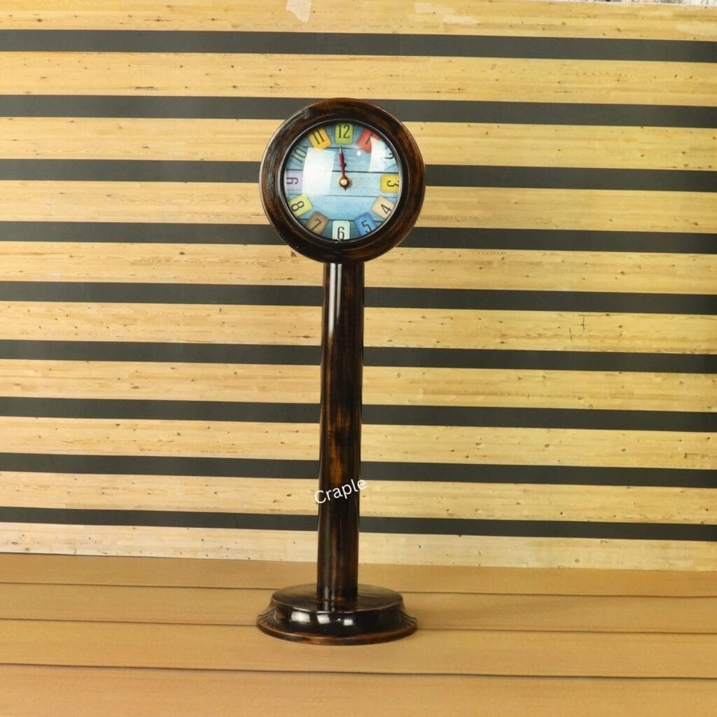 A tall wooden pedestal clock with a brown-black antique finish and a playful, colorful tiled number dial.