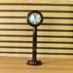 A tall wooden pedestal clock with a brown-black antique finish and a playful, colorful tiled number dial.