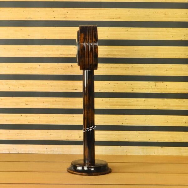 Side profile of the antique-finish wooden pedestal clock, showcasing its slender and elegant stand.