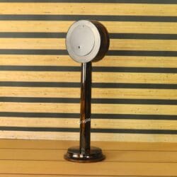 The back of the round wooden pedestal clock, showing the mechanism cover and sturdy base.