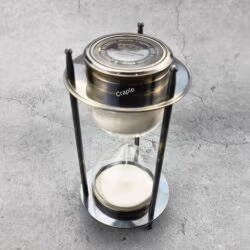A 5-minute hourglass sand timer with a black antique brass frame and a built-in compass on top.