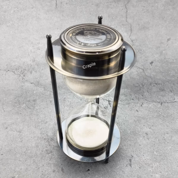 A 5-minute hourglass sand timer with a black antique brass frame and a built-in compass on top.