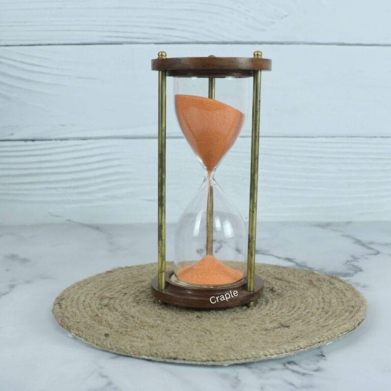 A handcrafted 5-minute hourglass with vibrant orange sand, framed by round wooden bases and shiny brass pillars.