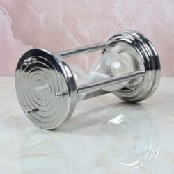 The 10-minute steel hourglass resting horizontally, showcasing its sturdy pillar construction and white sand.