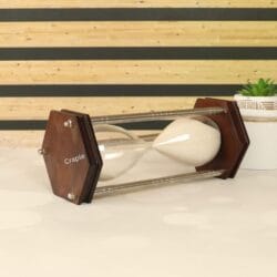 Side view of the 30-minute hourglass lying down, highlighting its clean lines and sturdy construction.