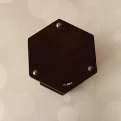 Top-down view of the hexagonal dark wood base of the hourglass, showing the nickel hardware details.