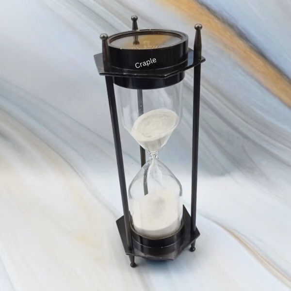 Angled profile of the antique-finish brass hourglass, highlighting its hexagonal base and support pillars.