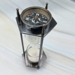 Angled view focusing on the vintage-style compass at the top of the 3-minute sand timer.