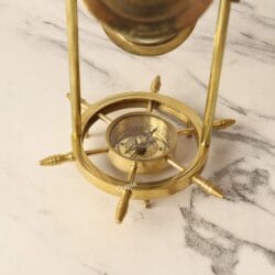 Top-down view focusing on the magnetic compass at the base of the rotating hourglass.