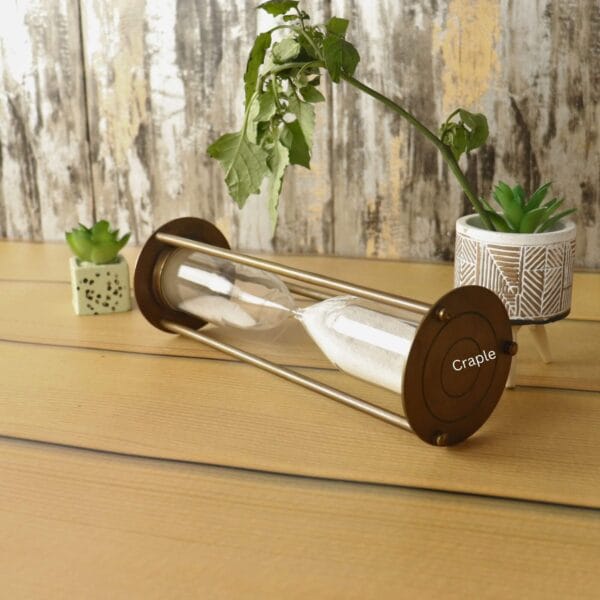 Close-up of the round brass base of the nautical sand timer while it's lying on its side.