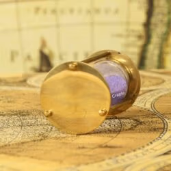 Close-up of the polished, shiny brass base of the petite 1-minute sand timer.