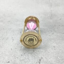 Close-up of the top of the brass hourglass, showing the detailed "Made for Royal Navy London" engraving.