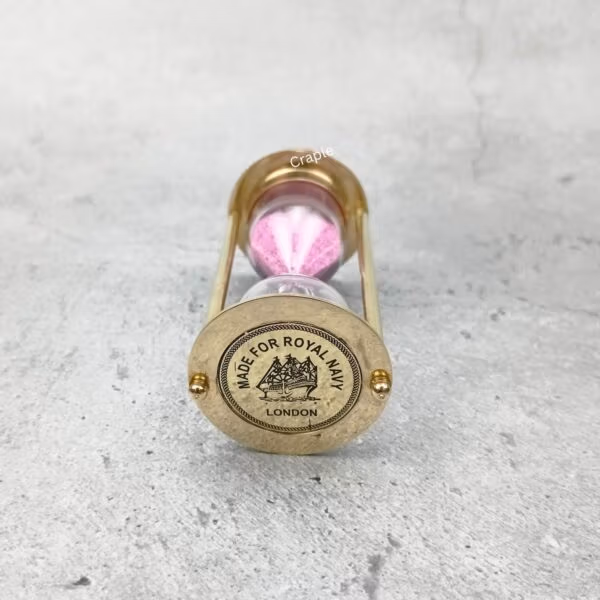 Close-up of the top of the brass hourglass, showing the detailed "Made for Royal Navy London" engraving.