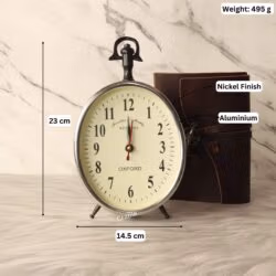 Silver aluminum desk clock with its dimensions labeled, showing a height of 23 cm and a width of 14.5 cm.