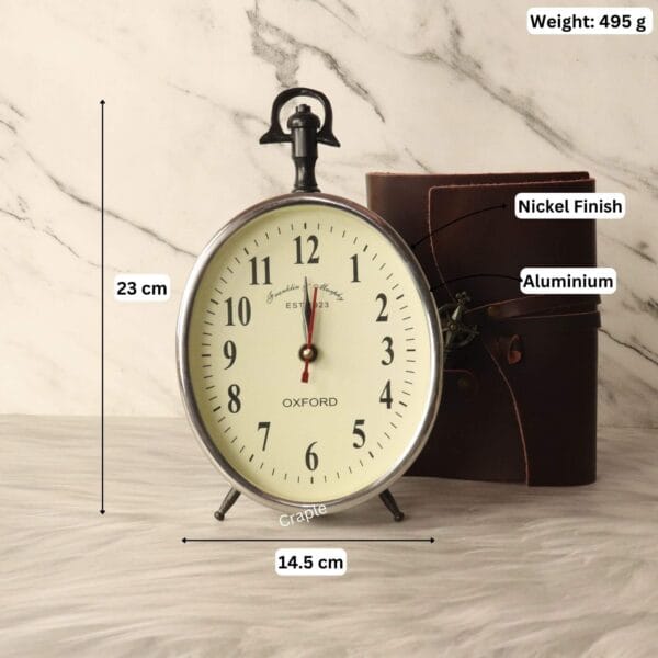 Silver aluminum desk clock with its dimensions labeled, showing a height of 23 cm and a width of 14.5 cm.