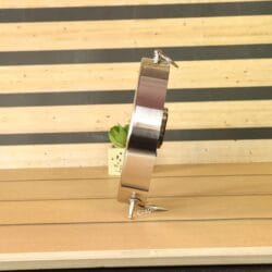 A side profile of the round silver aluminum table clock, highlighting its solid construction and depth.