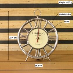 Silver skeleton clock with its dimensions labeled, showing a height of 18.4 cm and a width of 16.3 cm.