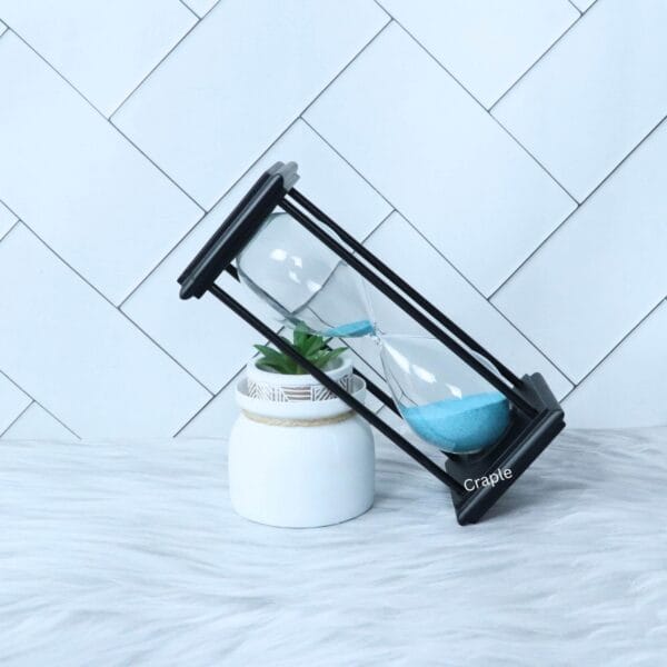 The sky blue sand hourglass tilted at a dynamic angle, with sand flowing between the bulbs.