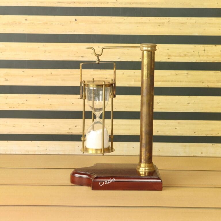 A vintage-style 5-minute hourglass with white sand, hanging from an antique brass stand with a wooden base.