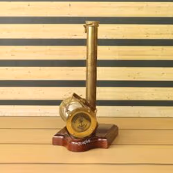 The side view of the wooden base, showing the integrated antique brass compass.